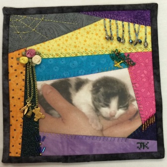 Janis Katz - crazy quilt square with hands and cat